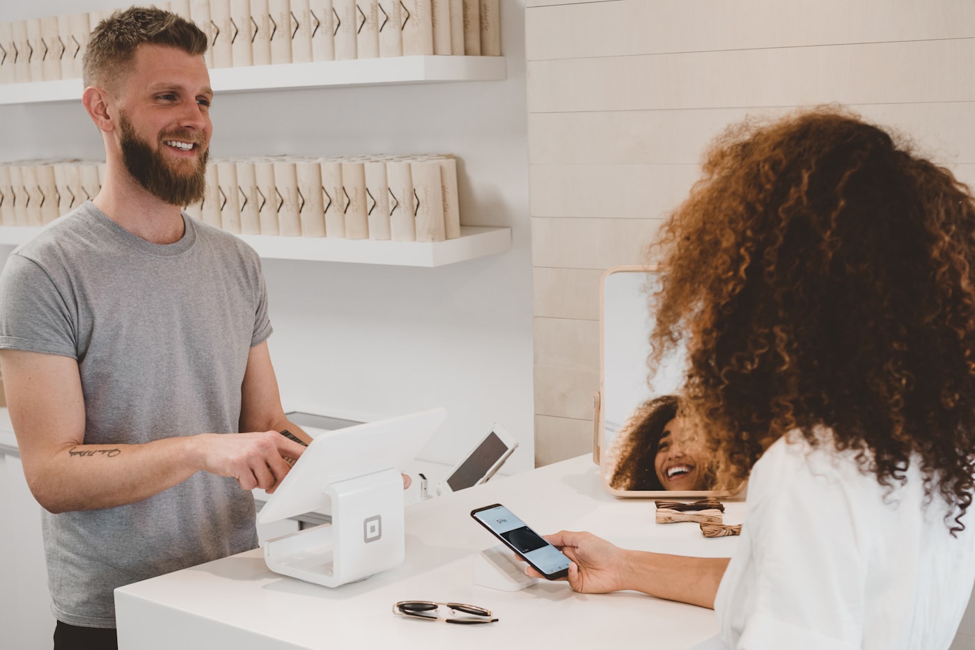 Guest paying with a phone at the counter