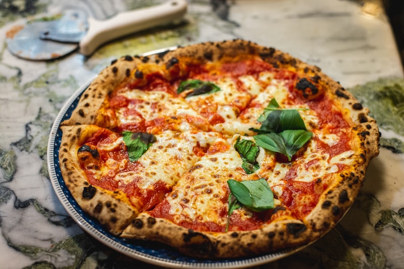 Wood-fired Margherita pizza featured on the menu board