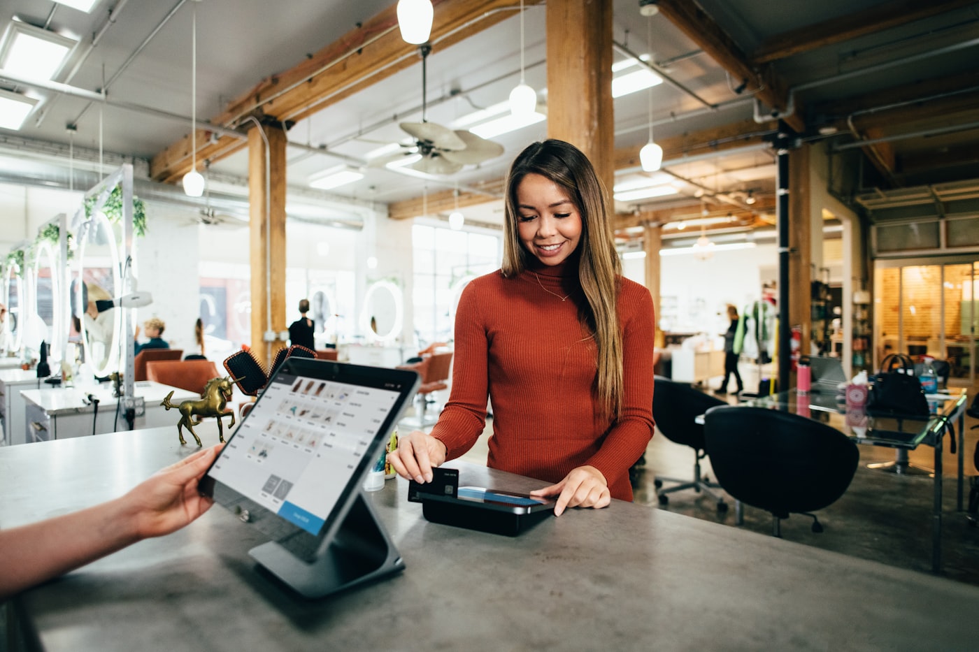 Staff processing a card payment at the counter